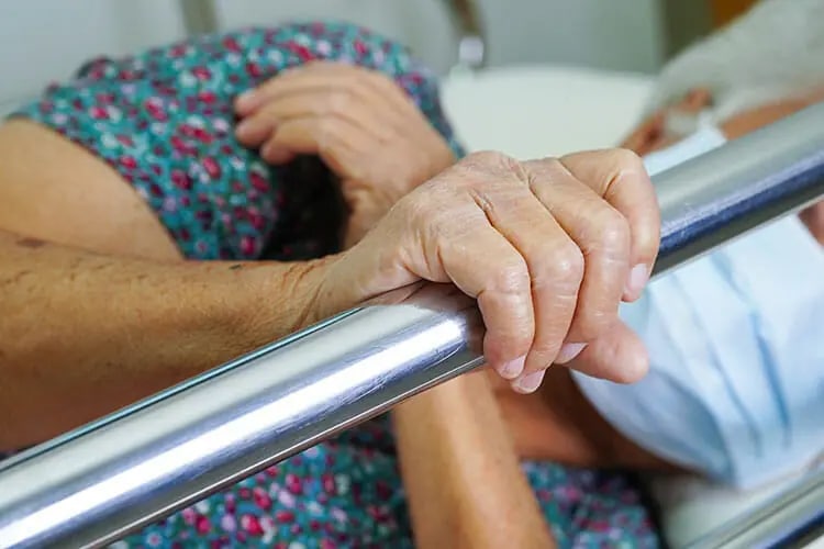 elderly woman in assisted bed