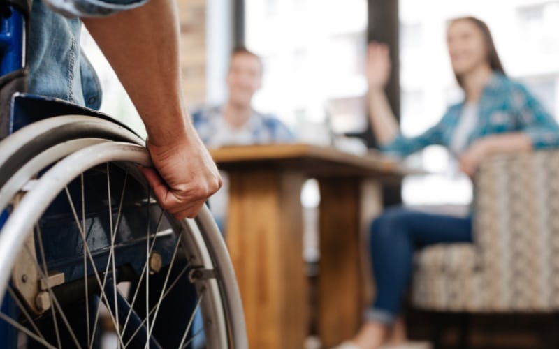 person in wheelchair at office to discuss Catastrophic Injury Claim