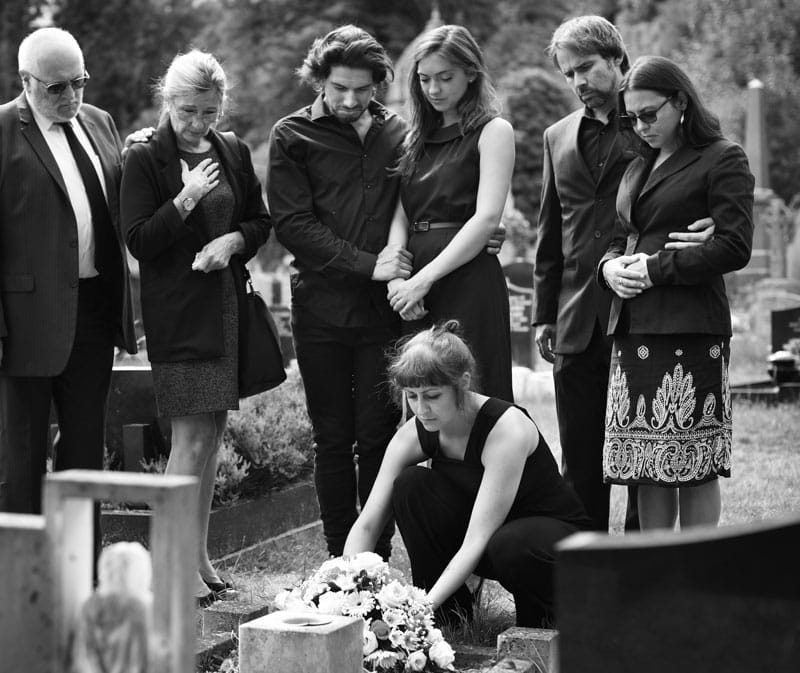family at burial site of loved one