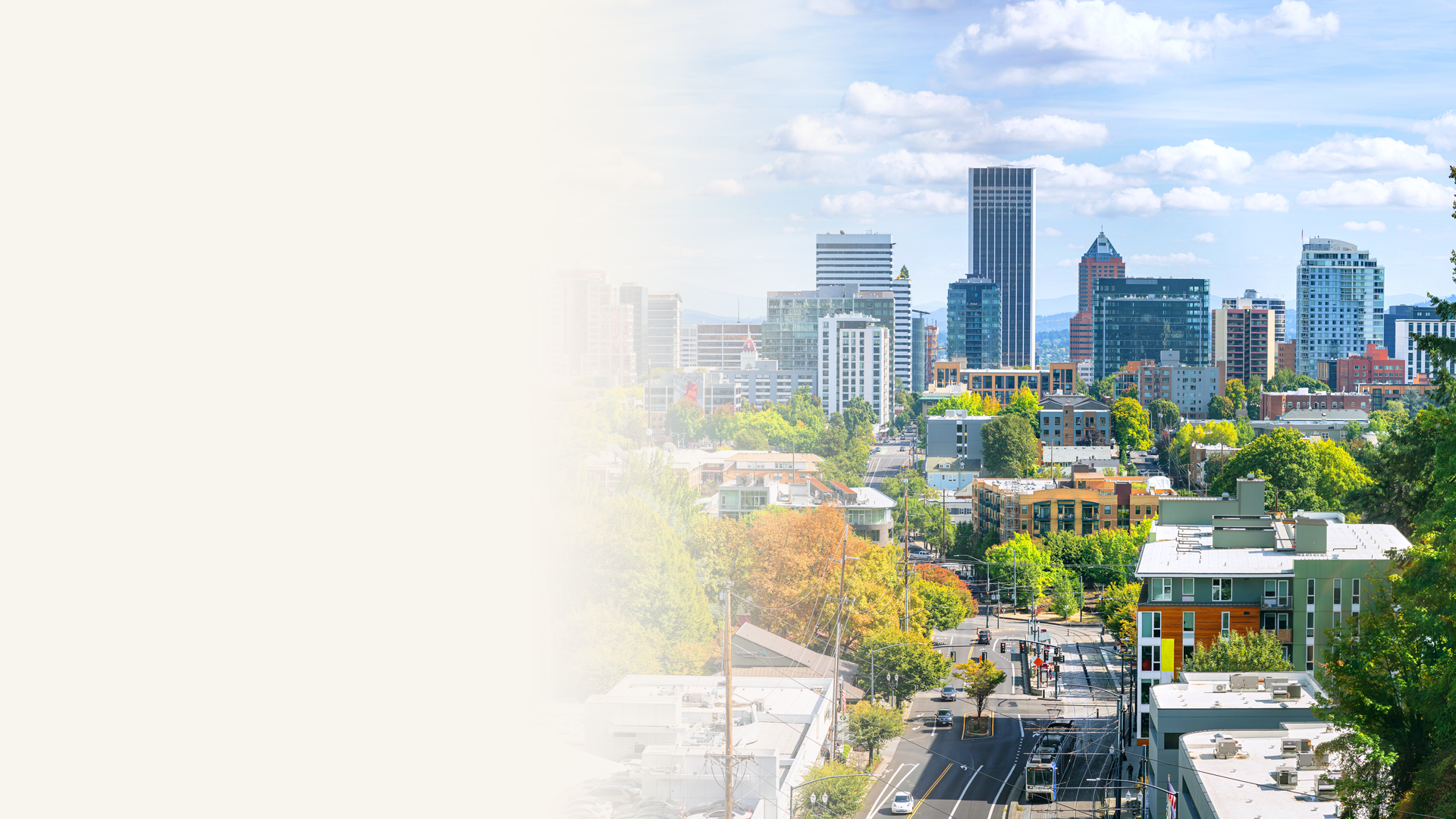 Downtown Portland, Oregon skyline on a sunny day with tree-lined neighborhoods in the foreground