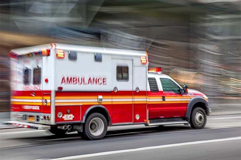Ambulance responding to a car accident scene for emergency medical evaluation