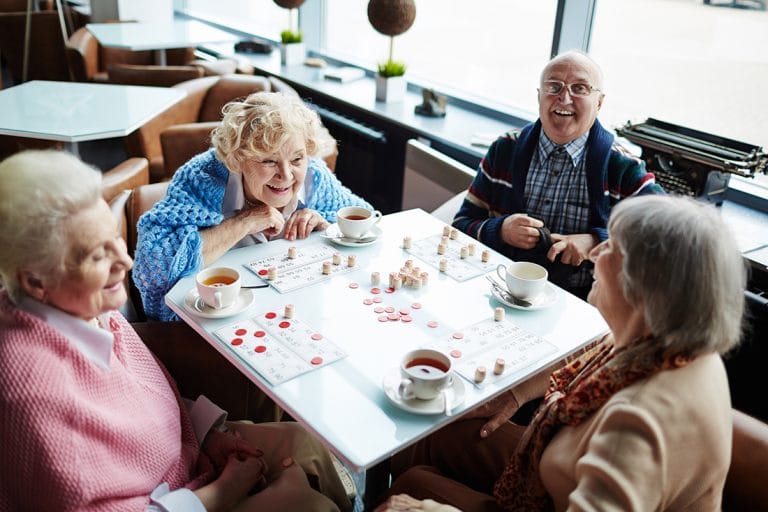 Four elderly folks playing bingo