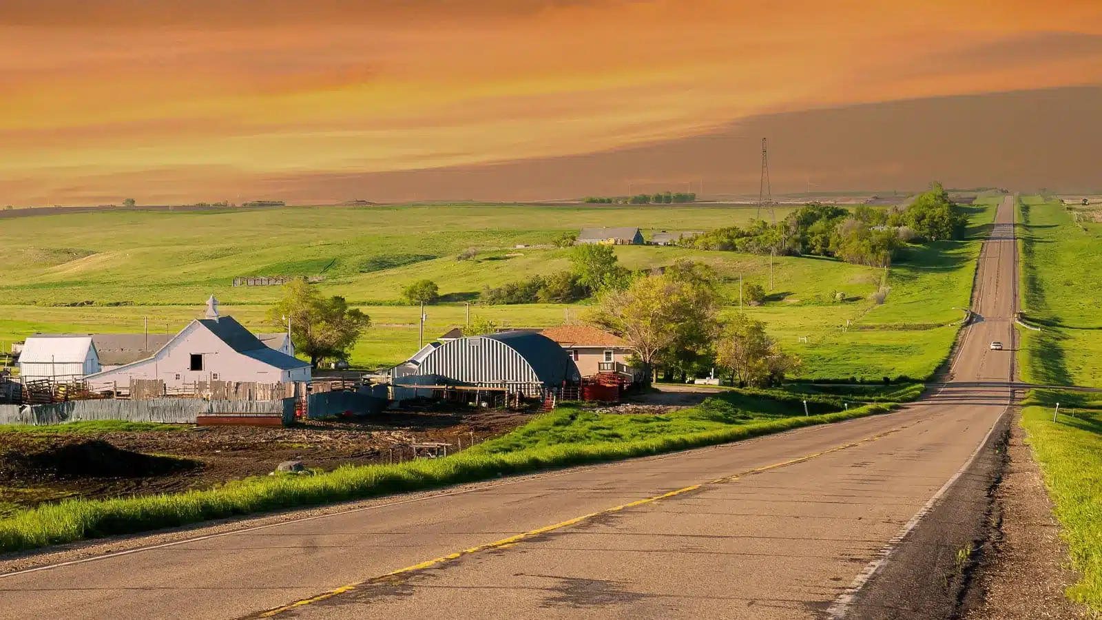 A two-lane North Dakota highway stretching through open prairie under a wide sky, the kind of rural road where most of the state's fatal crashes happen