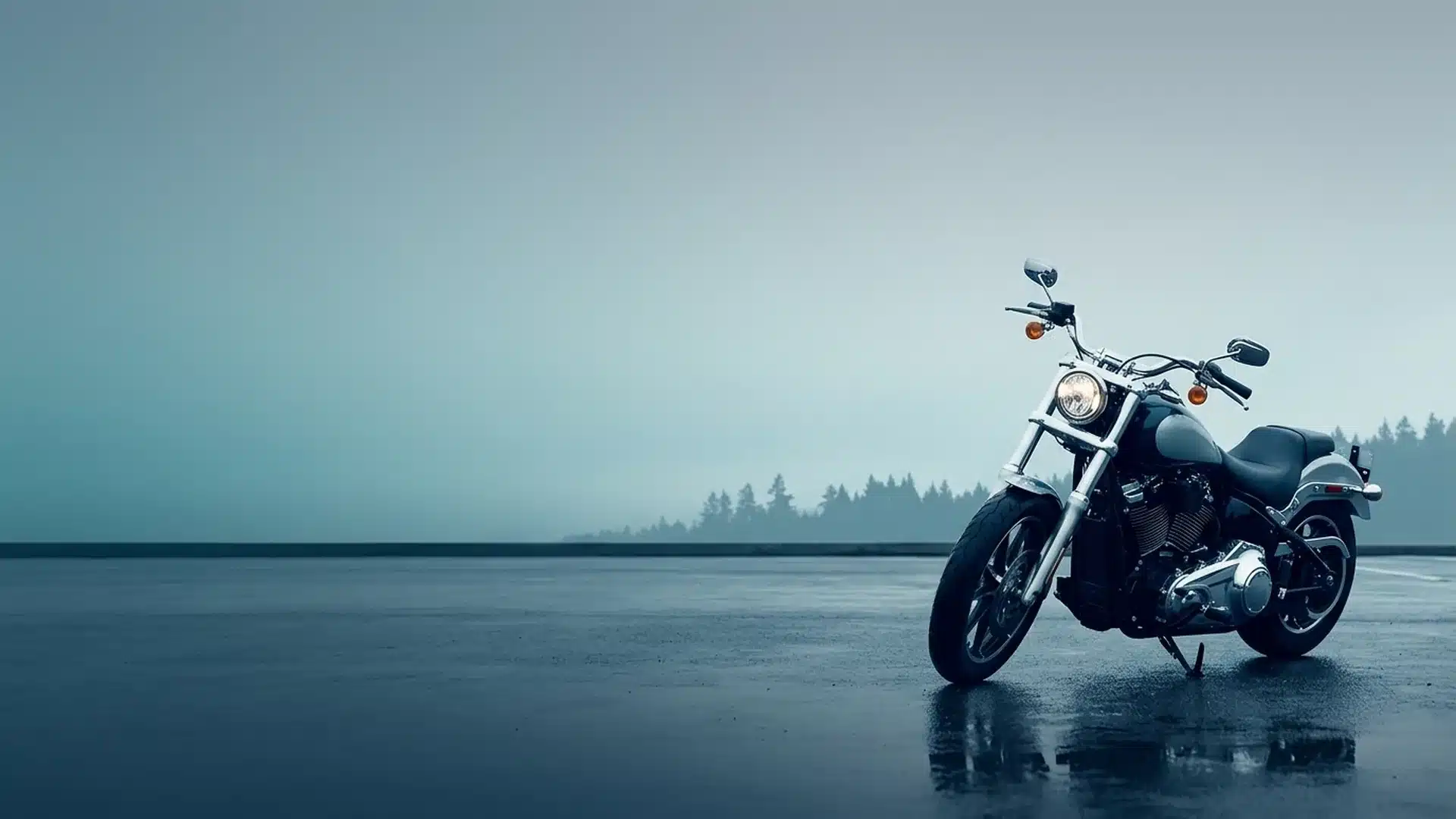 Motorcycle parked on wet pavement under an overcast Pacific Northwest sky