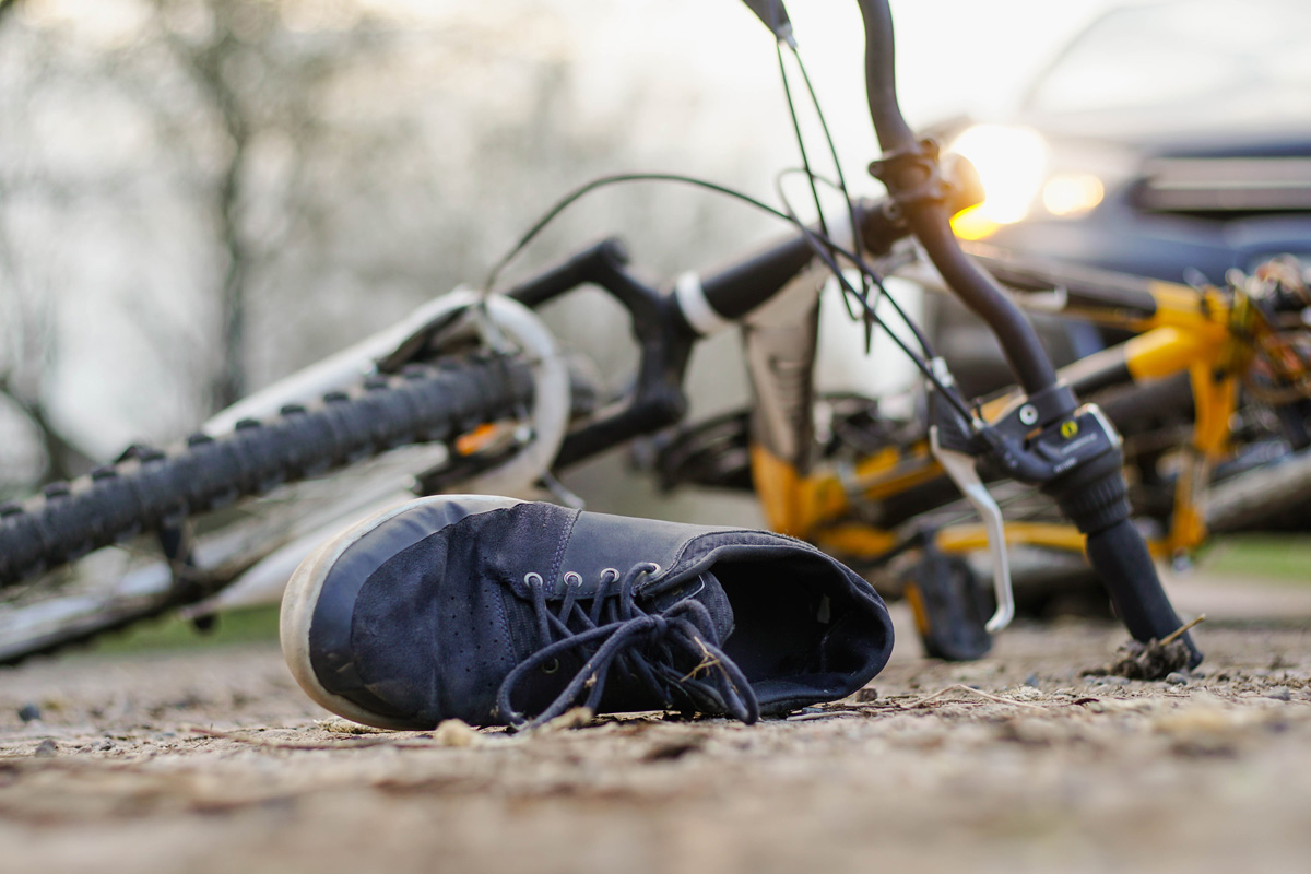 shoe near bicycle that was hit by car
