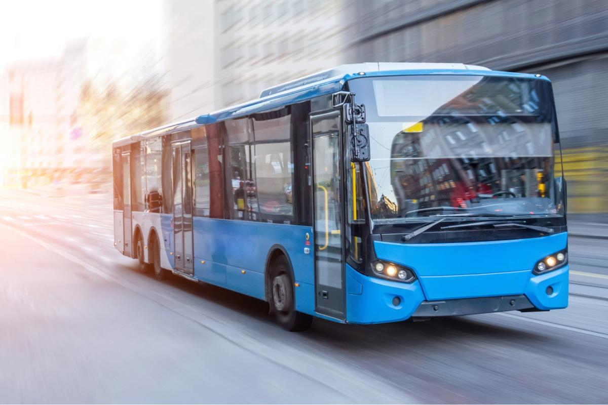 blue colored bus in city