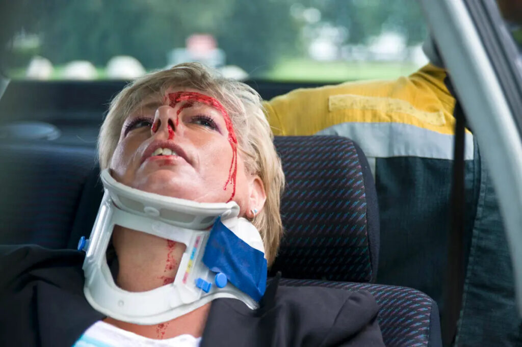 woman beleeing and in neck brace after car accident