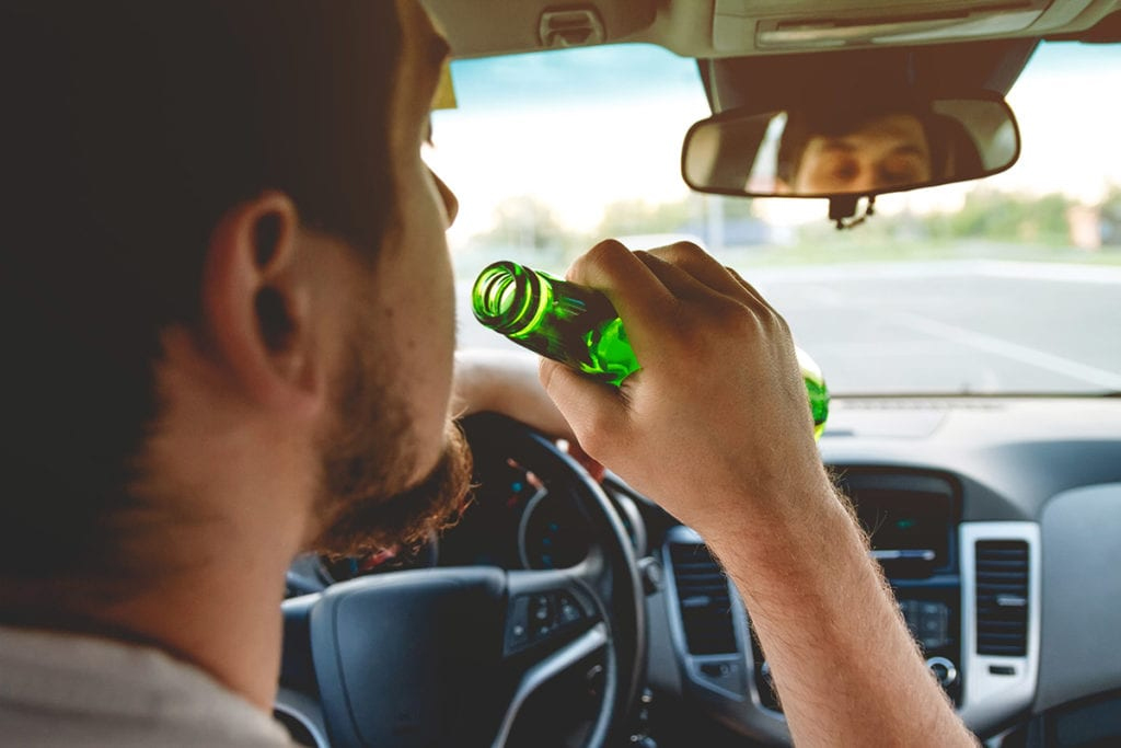 man drinking while drving