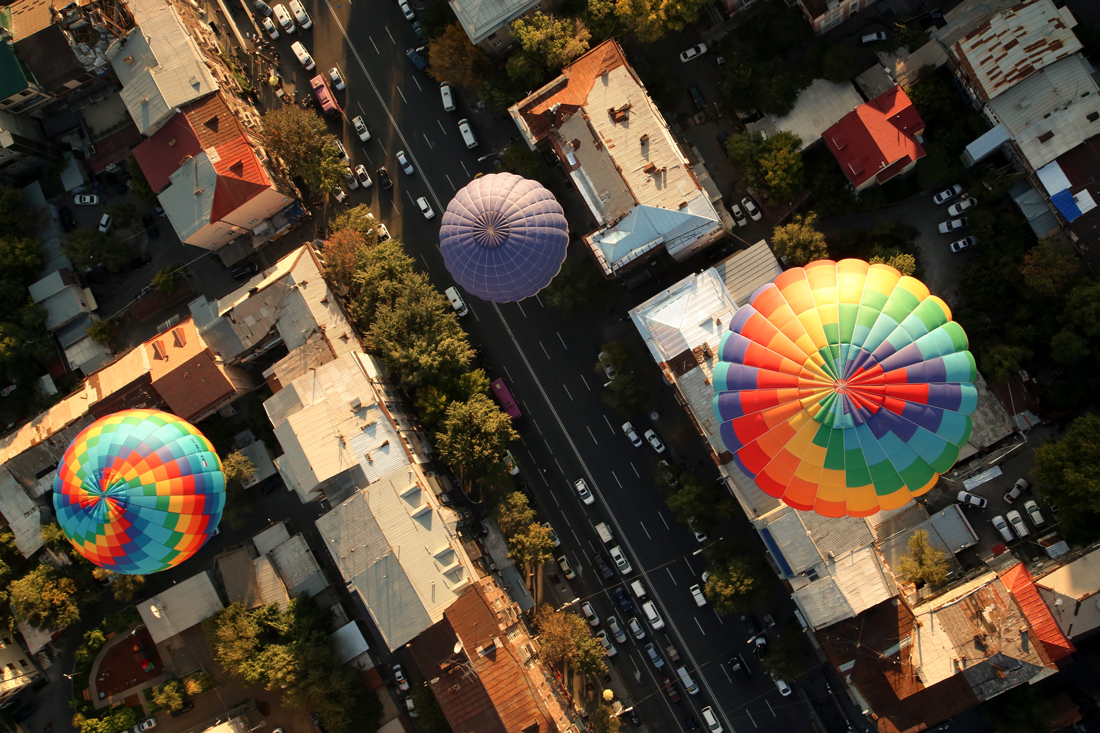 parachutes over city