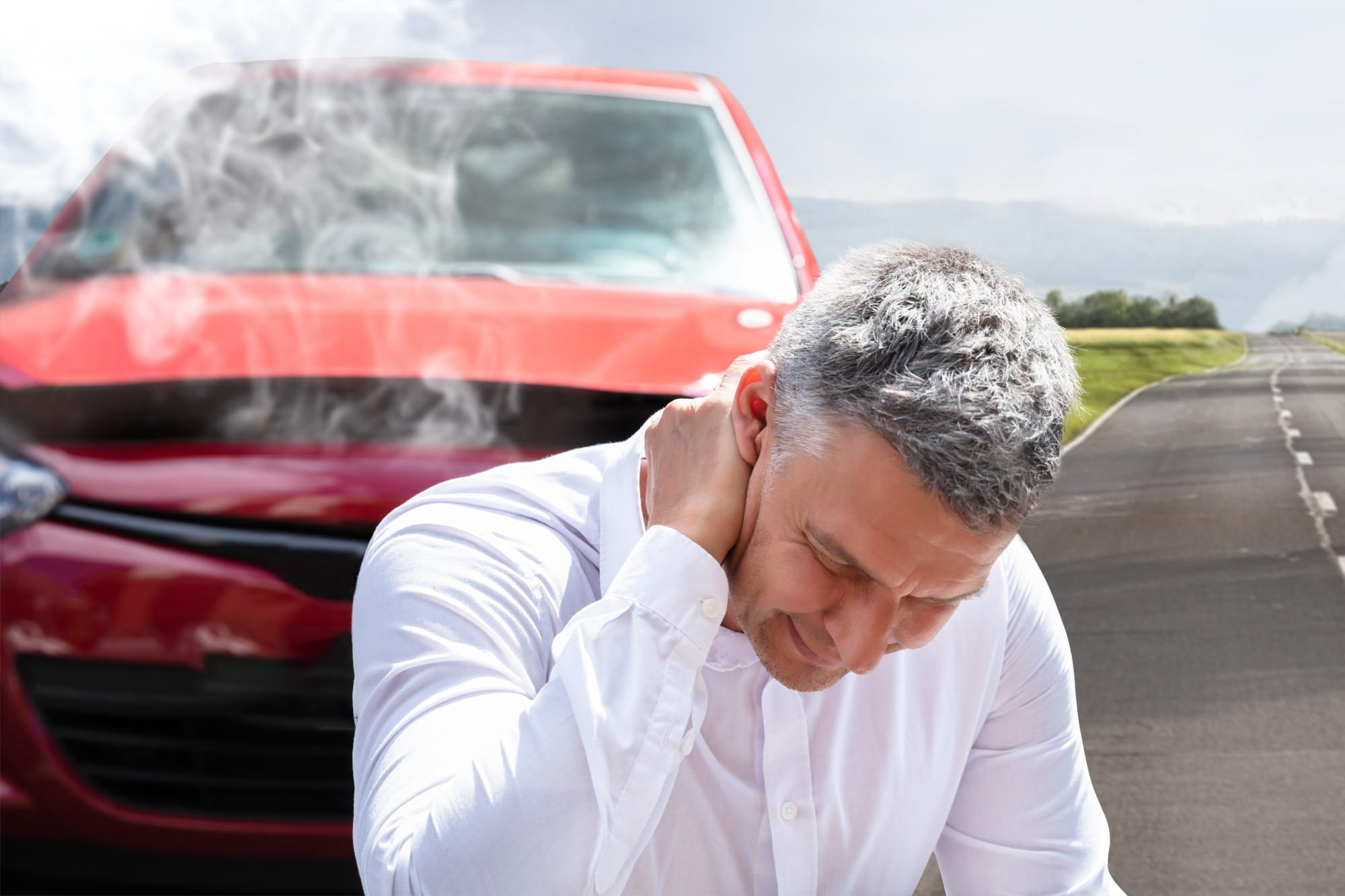 man next to car crash holding neck from pain