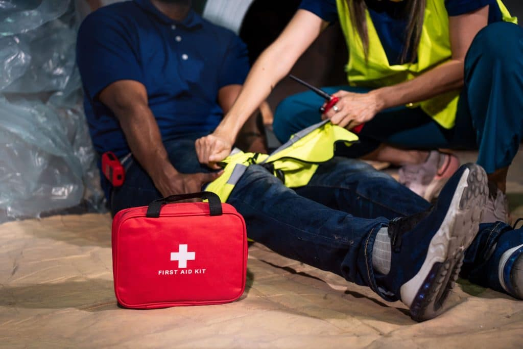 construction worker injured leg first aid kit