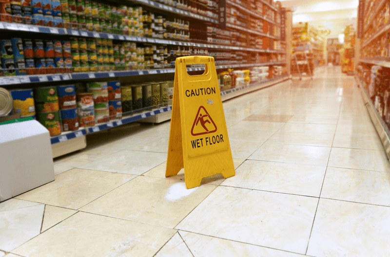caution sign in wet floor in super market isle